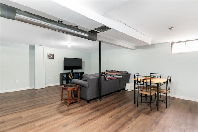 living room featuring visible vents, wood finished floors, and baseboards