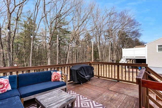 deck with an outdoor living space and a grill