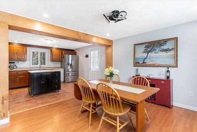 dining room featuring recessed lighting, baseboards, and light wood-style floors