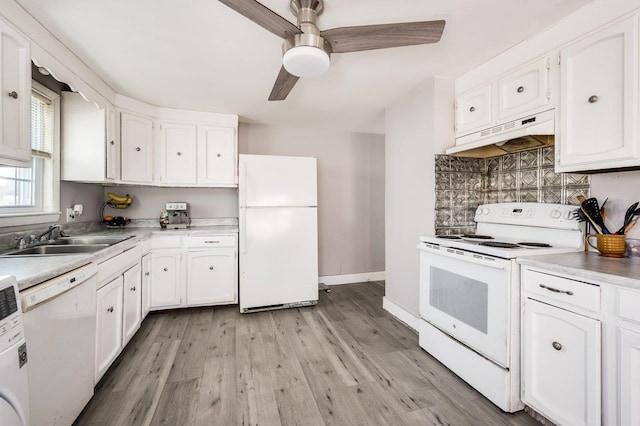 kitchen with under cabinet range hood, a sink, white cabinetry, white appliances, and light wood-style floors