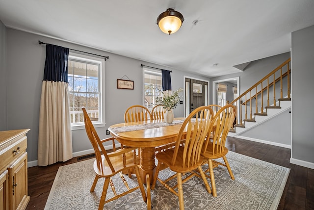 dining space with visible vents, baseboards, dark wood finished floors, and stairs