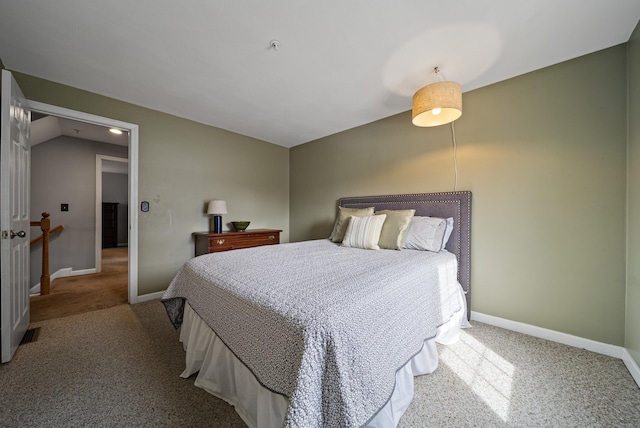 bedroom featuring baseboards, lofted ceiling, and carpet floors