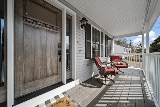 wooden terrace featuring covered porch