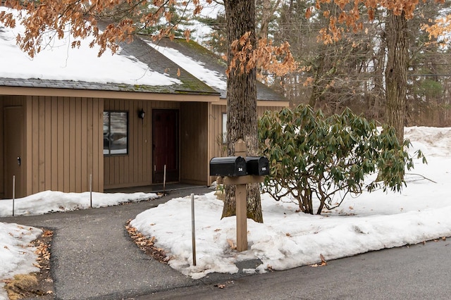 view of snow covered property entrance