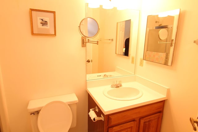 half bathroom with toilet and vanity