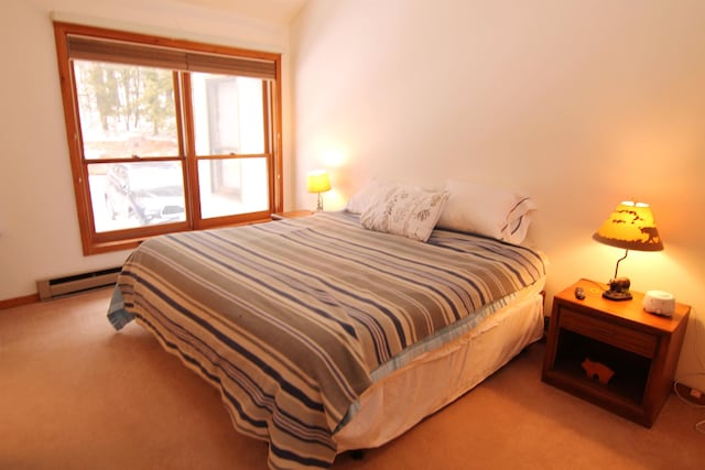 bedroom featuring a baseboard heating unit and carpet floors