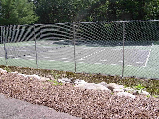 view of tennis court featuring fence