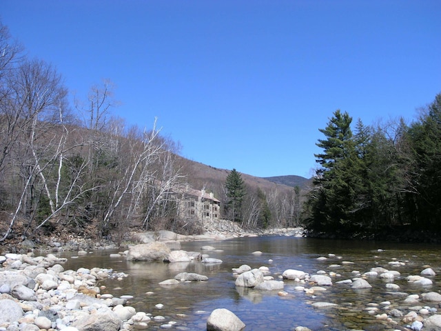 view of water feature with a view of trees and a mountain view