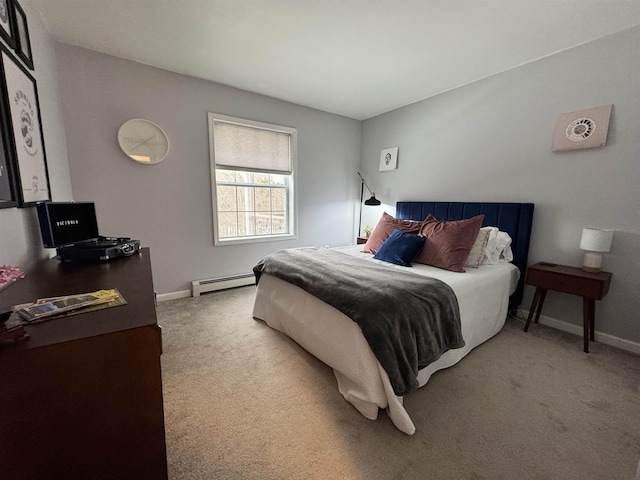 carpeted bedroom featuring a baseboard heating unit and baseboards