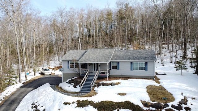 single story home featuring stairway, a shingled roof, and aphalt driveway