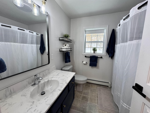 bathroom with vanity, toilet, and a baseboard radiator