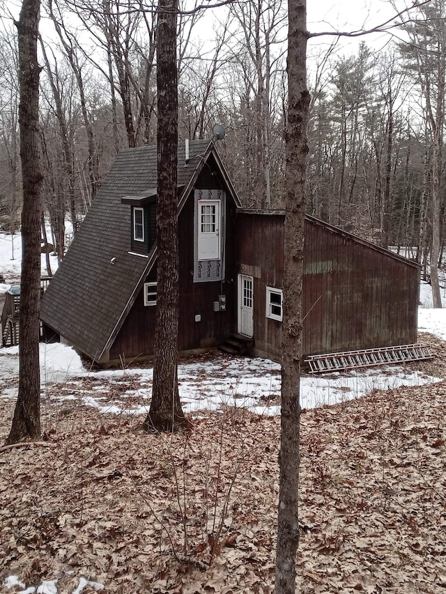 view of front of house featuring entry steps and a shingled roof