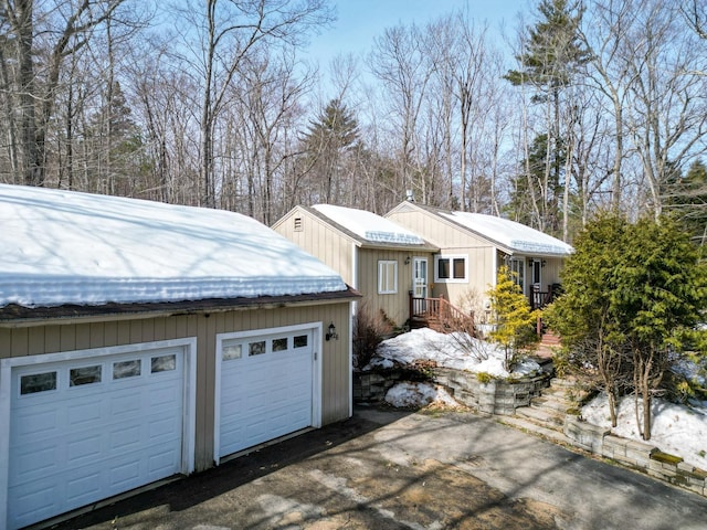 view of home's exterior with an outdoor structure and a detached garage