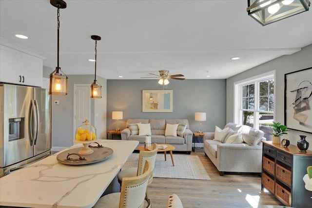 living area with a ceiling fan, light wood-style flooring, and recessed lighting