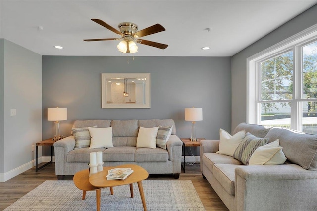 living room featuring recessed lighting, ceiling fan, baseboards, and wood finished floors