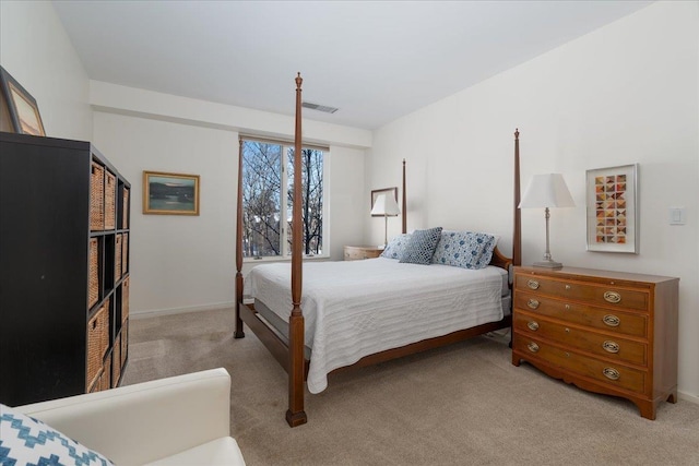 bedroom featuring visible vents, baseboards, and light colored carpet