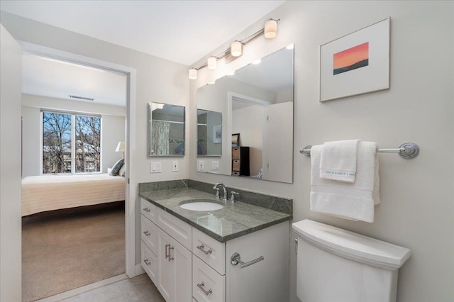 ensuite bathroom featuring vanity, visible vents, tile patterned flooring, ensuite bathroom, and toilet