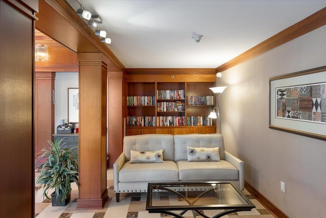 sitting room with crown molding and baseboards