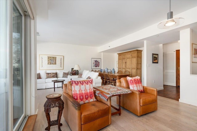 living area with light wood-style floors and baseboards