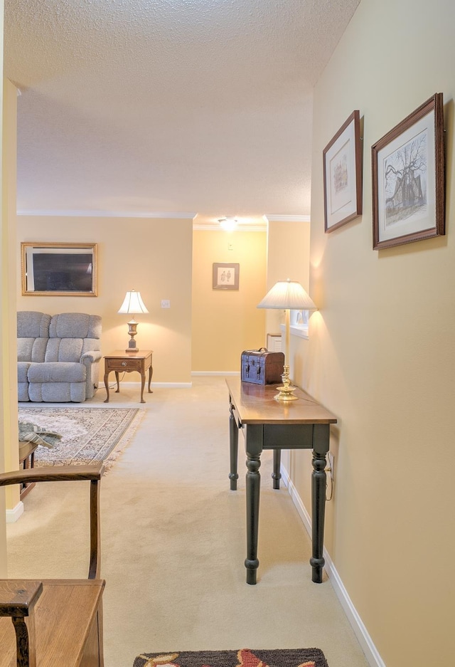 hallway with baseboards, a textured ceiling, ornamental molding, and carpet flooring