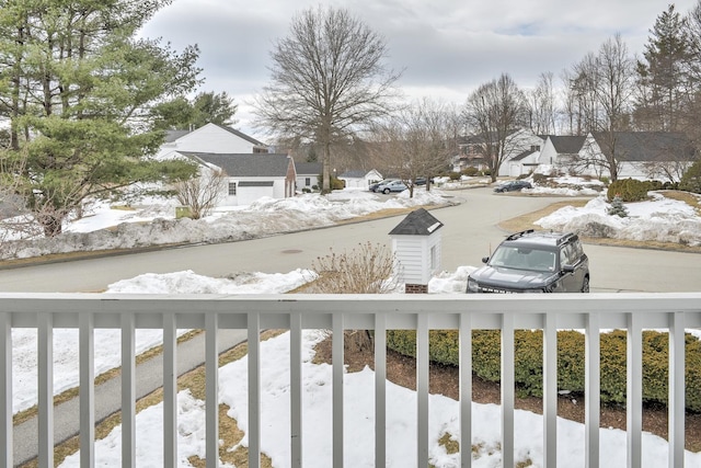 yard covered in snow with a residential view