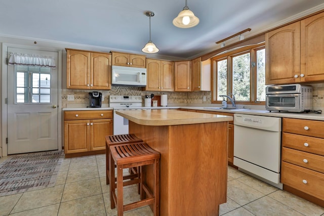 kitchen featuring white appliances, light tile patterned flooring, light countertops, and a sink