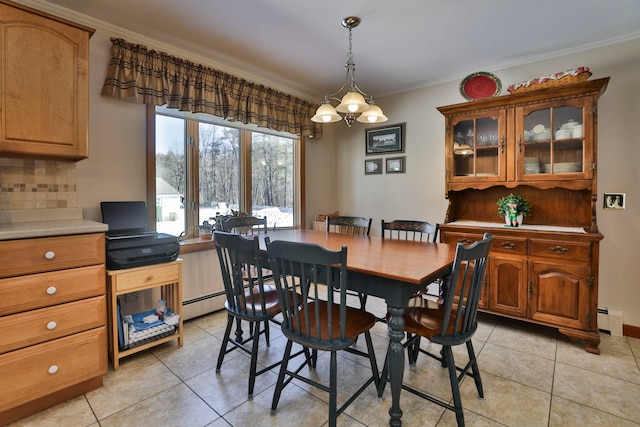 dining area featuring light tile patterned floors, a baseboard radiator, and crown molding