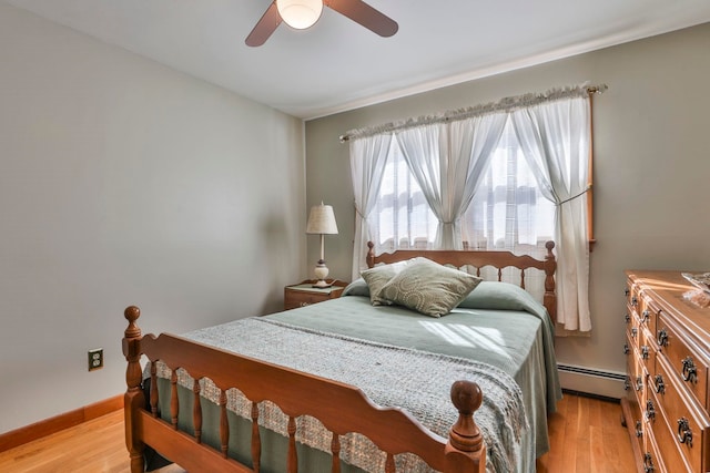 bedroom with light wood-type flooring, a baseboard radiator, baseboards, and ceiling fan