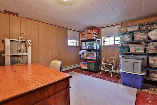 office space with wooden walls, a healthy amount of sunlight, a baseboard heating unit, and brick floor