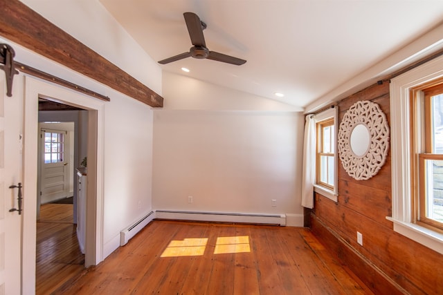 spare room featuring vaulted ceiling, a barn door, recessed lighting, and light wood finished floors