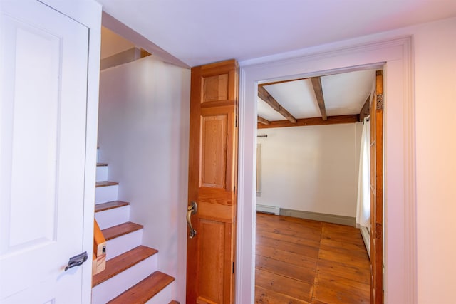 hall with beam ceiling, stairway, light wood finished floors, and a baseboard radiator