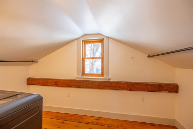 spacious closet with lofted ceiling and wood finished floors