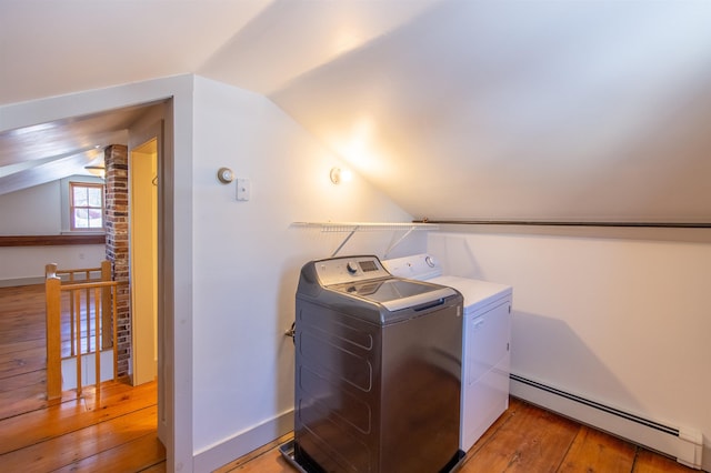 clothes washing area with light wood-style flooring, separate washer and dryer, a baseboard radiator, baseboards, and laundry area