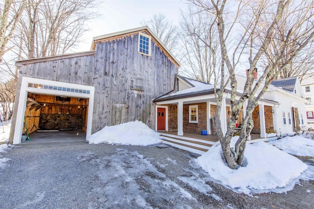 view of front of property featuring covered porch and a garage