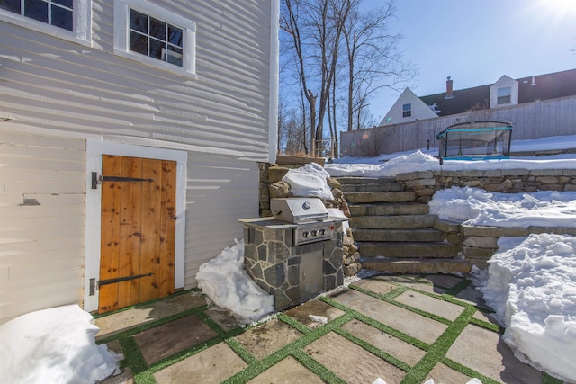 view of property exterior featuring a trampoline and fence