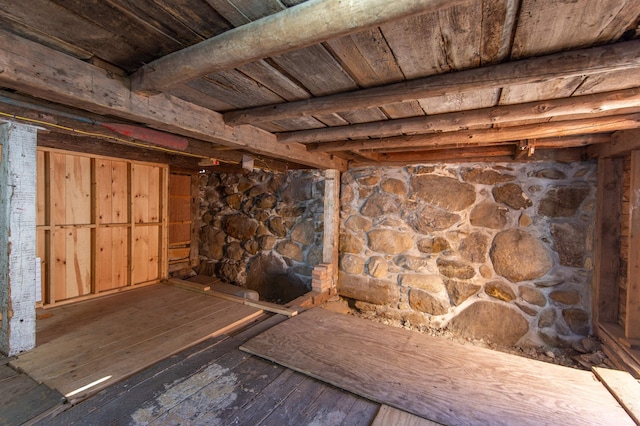 below grade area with wood-type flooring and wooden ceiling