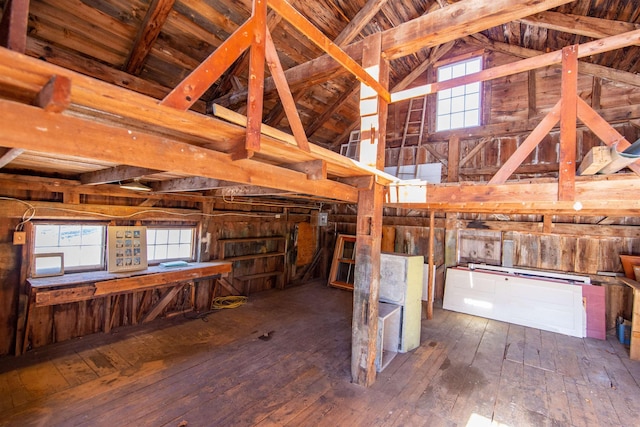 miscellaneous room with hardwood / wood-style flooring and lofted ceiling