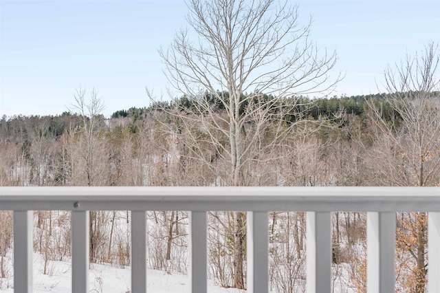 exterior space featuring a wooded view