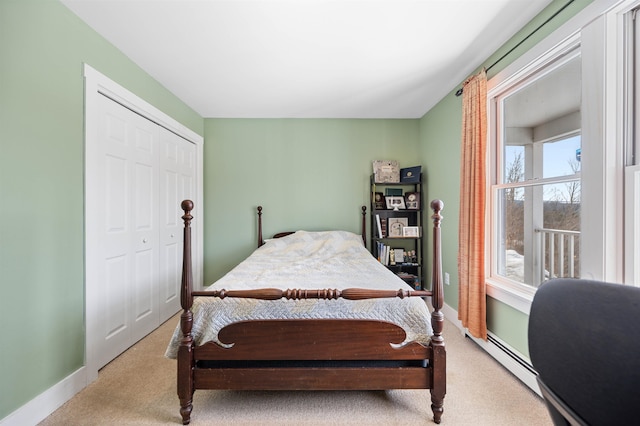 bedroom with light carpet, a closet, and baseboards