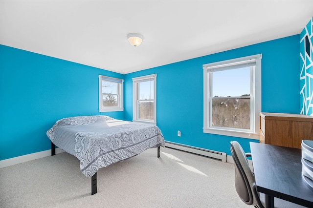 bedroom with baseboard heating, multiple windows, carpet flooring, and baseboards