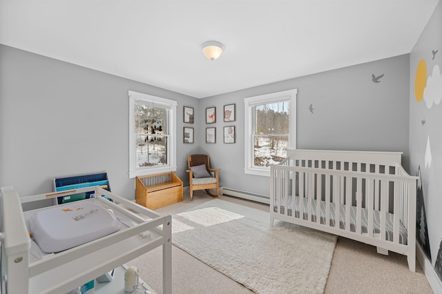 carpeted bedroom with a nursery area and baseboard heating