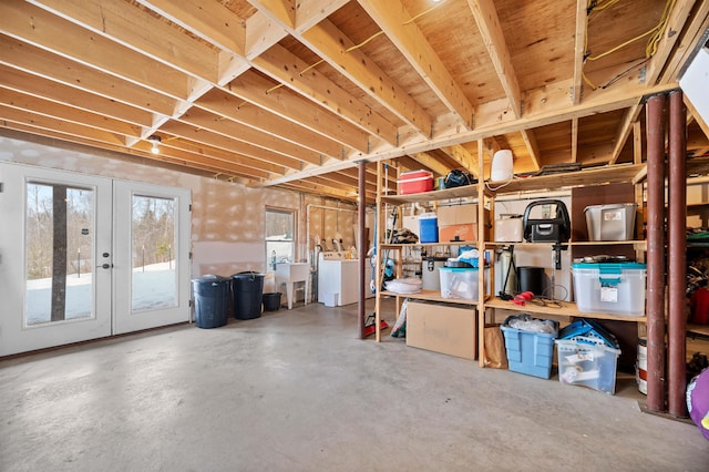 below grade area featuring washer / dryer and french doors