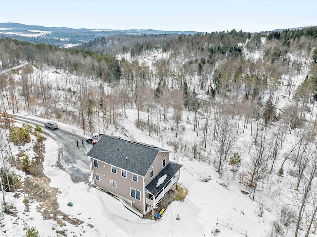 snowy aerial view with a mountain view