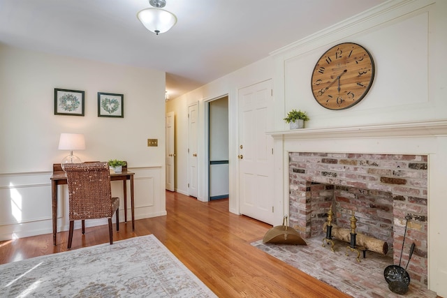 office with a wainscoted wall, wood finished floors, and a decorative wall