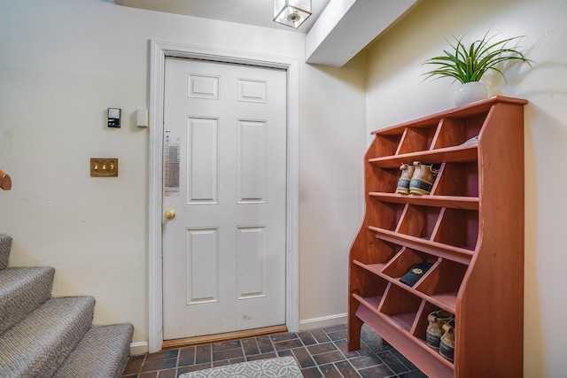 interior space featuring stone finish flooring and baseboards