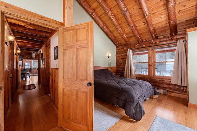 bedroom with beam ceiling, wooden ceiling, and hardwood / wood-style flooring