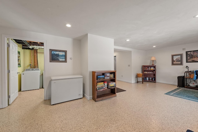 interior space featuring recessed lighting, speckled floor, baseboards, and washer / dryer