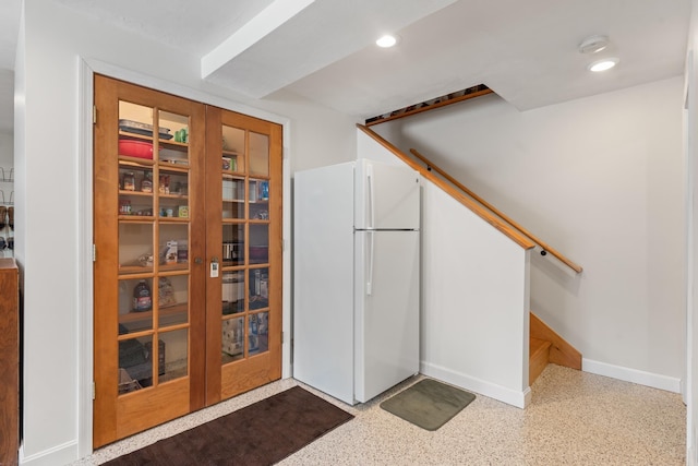 interior space with recessed lighting, baseboards, and freestanding refrigerator