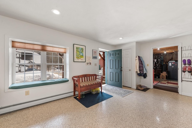 foyer entrance featuring recessed lighting, speckled floor, a baseboard heating unit, and baseboards