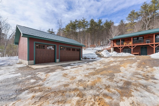 snow covered garage featuring a garage